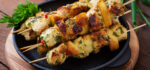 Chicken skewers with slices of apples and chili